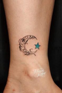 a small tattoo on the foot of a woman with a crescent and star in it