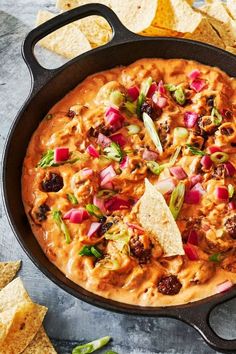 a skillet filled with tortilla chips and salsa