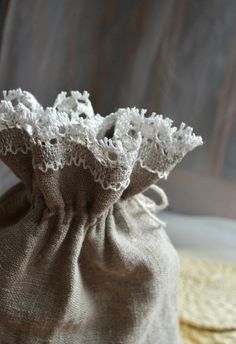 a small bag with white lace on it