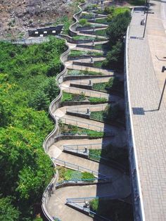 an aerial view of a curved walkway in the park