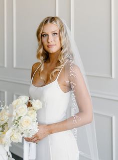 a woman in a wedding dress holding a bouquet