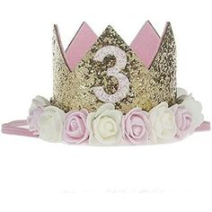 a pink and gold crown with flowers on the bottom, number three in the middle