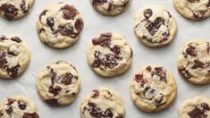 chocolate chip cookies are lined up on a baking sheet