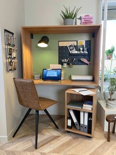 a computer desk with a laptop on top of it next to a chair and table