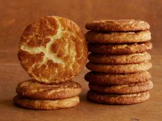 a stack of cookies sitting next to each other on top of a wooden table with an egg in the middle