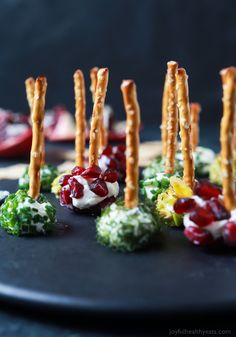 small appetizers are arranged on a black plate