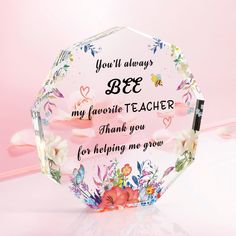 a clear glass award with flowers and butterflies on the side that says, you'll always bee my favorite teacher for helping me grow