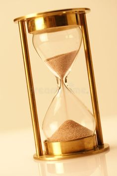 an hourglass with sand running through it on a white surface royalty images and stock photos