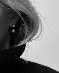 black and white photograph of woman wearing earrings