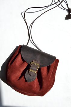 Handmade genuine leather and suede crossbody bag Leather on back side and cover Suede on body Adjustable leather rope handle Available in 5 different colors Dimensions: 15 cm x 18 cm Leather Pouch Bag With Leather Strap, Leather Pouch Bag With Strap, Red Leather Pouch For Everyday Use, Leather Shoulder Bag With Mobile Phone Bag In Burgundy, Burgundy Leather Shoulder Bag With Mobile Phone Pouch, Burgundy Leather Shoulder Bag With Phone Holder, Burgundy Leather Shoulder Bag With Mobile Phone Holder, Burgundy Leather Pouch Shoulder Bag, Unique Leather Bag