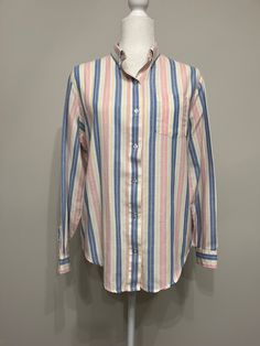 "This vintage Sears shirt is crisp and classic!  It's from around the 70s, early 80s.  The fabric is 60% cotton and 40% polyester.  It has a very summer casual preppy vibe.  The shirt is in excellent condition!  It's hard to believe it's 40-50 years old.  It is a ladies size 18. Vintage sizing often varies from today's sizing.  70s clothing tends to run small.  Please see measurements below.  This shirt would be so cute for a baby shower with the pastel pink, blue, yellow & white stripes.  I just love this colorful pastel shirt!  Thanks for  looking! Measurements taken laying flat: please double for chest & waist Armpit to armpit 22\" Waist/middle 20.5\" Sleeves from shoulder seam 23\" Shoulders 16\" Length 26\"" Striped Collared Preppy Shirt, Preppy Striped Collared Shirt, Striped Preppy Shirt For Spring, Spring Striped Preppy Shirt, Preppy Striped Shirt For Spring, Striped Yarn-dyed Button-up Shirt, Yarn-dyed Striped Button-up Shirt, Classic Multicolor Shirt For Spring, Preppy Striped Button-up Shirt