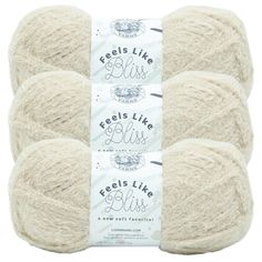 four skeins of wool yarn in white, with the words feels like bliss written on