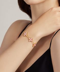 ✧ Material: 24K Yellow Gold Filled | 925 Sterling Silver ✧ Stone: Pink Shell + Diamond Simulant Adorn yourself with the delicate beauty of our 24K Gold Pink Shell Clover Bracelet, where elegance meets natural allure in a stunning piece of jewelry. Meticulously handcrafted, this bracelet is a true symbol of refined craftsmanship and timeless charm. Craftsmanship and Materials: Each bracelet is meticulously crafted with a solid layer of 24K gold over a 925 sterling silver base, ensuring durability Elegant Pink Gold-plated Bracelets, Exquisite Rose Gold Bracelets For Gifts, Pink Gold Plated Bracelets, Gold Plated Chain Bracelet For Her, Pink Gold Plated Bracelet, Pink Gold-plated Bracelet, Luxury Flower-shaped Bracelets As Gift, Luxury Gold Flower Bracelet, Feminine Gold Bangle Bracelets