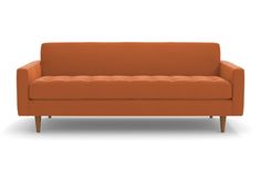 an orange couch sitting on top of a white floor