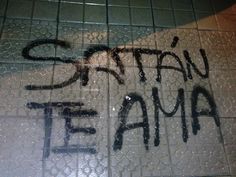 graffiti is spray painted on the floor of a public restroom