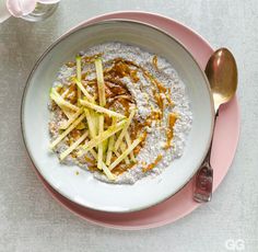 a bowl filled with oatmeal and toppings on top of a pink plate