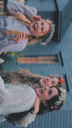 three young women dressed in wedding attire standing next to each other