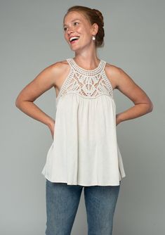 A sheer crochet-knit yoke adds a bohemian touch to this flowy tank top. Featuring a sexy racerback with a peek-a-boo keyhole detail. Perfect for festival season, we love to style this easy tank top with denim cut-offs and a simple sandal. Open knit crochet Textured floral jacquard Relaxed, flowy fit Sleeveless Crochet yoke Round neckline Racerback Back keyhole Hook & eye closure Bohemian crochet tank top Model is 5'9, wearing a size S.Style: I-13907W-RTW Spring Halter Top With Crochet Trim, Vacation Tank Top With Lace Trim, Spring Halter Neck Lace Top, Spring Halter Neck Top With Crochet Trim, Flowy Lace Top Casual Summer Style, Bohemian Flowy Tops With Crochet Trim, Bohemian Flowy Top With Crochet Trim, Flowy Bohemian Top With Crochet Trim, Bohemian Spring Camisole With Lace Top