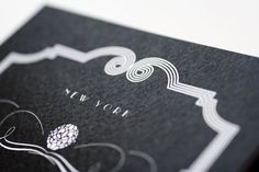 a black and white new york business card with an intricate design on the front cover