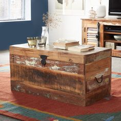 a wooden trunk sitting on top of a rug