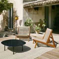 two chairs and a table on a patio