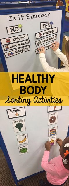 two children playing with healthy body sorting activities on a whiteboard in a classroom setting