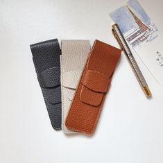 Leather pencil pouch is a beautiful gift for writers. You can customize your leather fountain pen case with a personalization and make it unique and exclusive.  Available in 14 different colors. The dimensions of this pen sleeve pouch are: 15,5 x 5,3 cm (6,10" x 2,10") It can hold 2 pens with a maximum length of 15 cm (5.9"). We can engrave it with initials or name (up to 4 characters). Choose the option from the drop-down menu and indicate in the personalization box the letters.  If you need to Leather Rectangular Pencil Case For Gift, Modern Leather Pencil Case For Daily Use, Leather Pencil Case With Pen Holders For Office, Leather Pencil Case With Pen Slots For Daily Use, Leather Fountain Pen Case, Leather Pencil Case, Leather Dye, Custom Pens, Pen Pouch