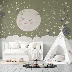 a child's bedroom with a teepee tent and stars on the wall behind it