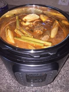 a crock pot filled with food sitting on top of a counter