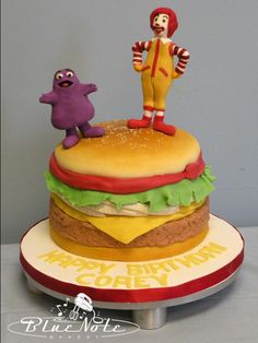 a birthday cake with an image of a man on top of a hamburger