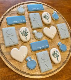 some cookies are arranged on a plate with blue and white icing that says, i do