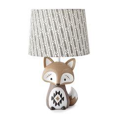 a little fox lamp with a fabric shade on it's head, sitting in front of a white background