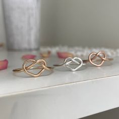 The sweetest little love knot to add to your ring collection, wear it in a fun stack or if you're a lover of all things minimalistic you'll rock it alone. Each and every ring is hand-made for you in our studio at the time of order in sterling silver or 14kt gold or rose gold-filled. Made to mix and match with other pieces from our collection. You're going to love creating your custom stack! This piece will ship from our studio in 1 to 2 weeks. * There may be a slight seam on gold filled or rose Modern Twist Infinity Stackable Rings As Gift, Adjustable Rings With A Modern Twist For Promise, Adjustable Infinity Stackable Rings With A Modern Twist, Adjustable Promise Ring With A Modern Twist, Modern Twist Adjustable Promise Ring, Adjustable Minimalist Heart Ring For Promise, Dainty Infinity Stackable Promise Rings, Dainty Infinity Stackable Rings For Gift, Adjustable Twisted Promise Ring