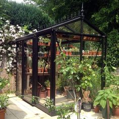 a small greenhouse with potted plants in it