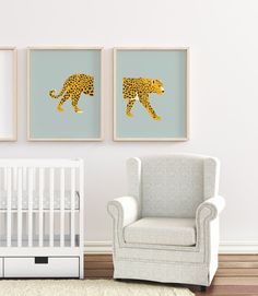 a baby's room with two framed pictures and a crib