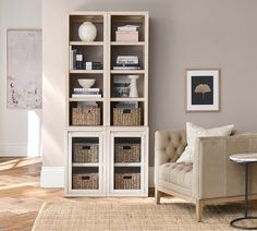 a living room filled with furniture and bookshelves next to a wall mounted painting