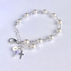 This lovely First Communion bracelet and earrings set is sure to be the perfect gift! The beautiful bracelet doubles as a single decade rosary. This classic bracelet has been a big seller as First Communion jewelry, Confirmation jewelry, Easter bracelet, Flower Girl gift, Maid-of-Honor jewelry, Bridesmaids matching bracelets, Mother-of-the-Bride jewelry, Godmother gift, and as Bridal jewelry. Description: -Bracelet measures 5 ½ inches plus a 1-inch extension chain -fits First Communion age (2nd Hypoallergenic Spiritual Wedding Jewelry, Hypoallergenic Spiritual Jewelry For Wedding, Dainty Rosary Bracelet Gift With Round Beads, Dainty Rosary Bracelet Gift, Elegant Crystal Bracelet With Charms For Gift, Elegant Crystal Charm Bracelet As A Gift, Elegant Crystal Charm Bracelet Gift, Sterling Silver Round Beads Jewelry For Birthday, Dainty Hypoallergenic Rosary Bracelet Gift