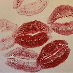 four lipstick imprints are shown on a piece of paper that has been colored red