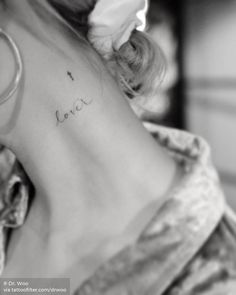 the back of a woman's neck with writing on it