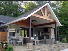 an outdoor living area with stone steps leading up to the front door and covered patio