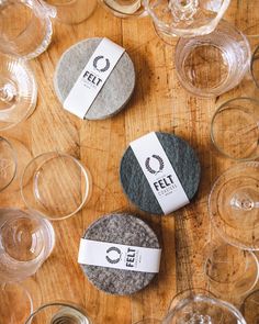 two rocks sitting next to each other on top of a wooden table covered in wine glasses