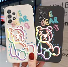 two cell phones with stickers on them in the shape of bears and bear cubs