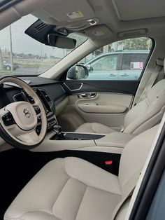 the interior of a car with beige leather seats