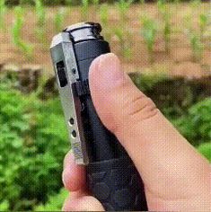 a person is holding a lighter in their left hand and pointing it at the camera