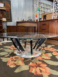 a glass table sitting on top of a rug