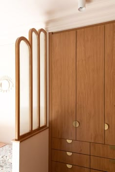 a bedroom with wooden cabinets and white walls