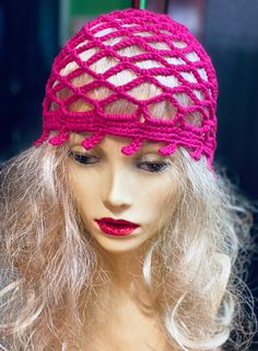 a mannequin head wearing a pink knitted hat