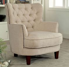 a living room with a chair and bookshelf in the corner, on carpeted floor