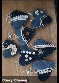 several pieces of blue fabric with white lace on them and some key chains attached to them