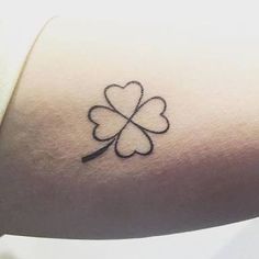 a four leaf clover tattoo on the arm